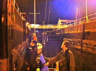 Going through the Ballard Locks at night in a Thunderbird sailboat.
