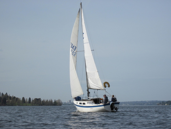A sailboat on a downwind jibe just off of Mercer Island in Lake Washington