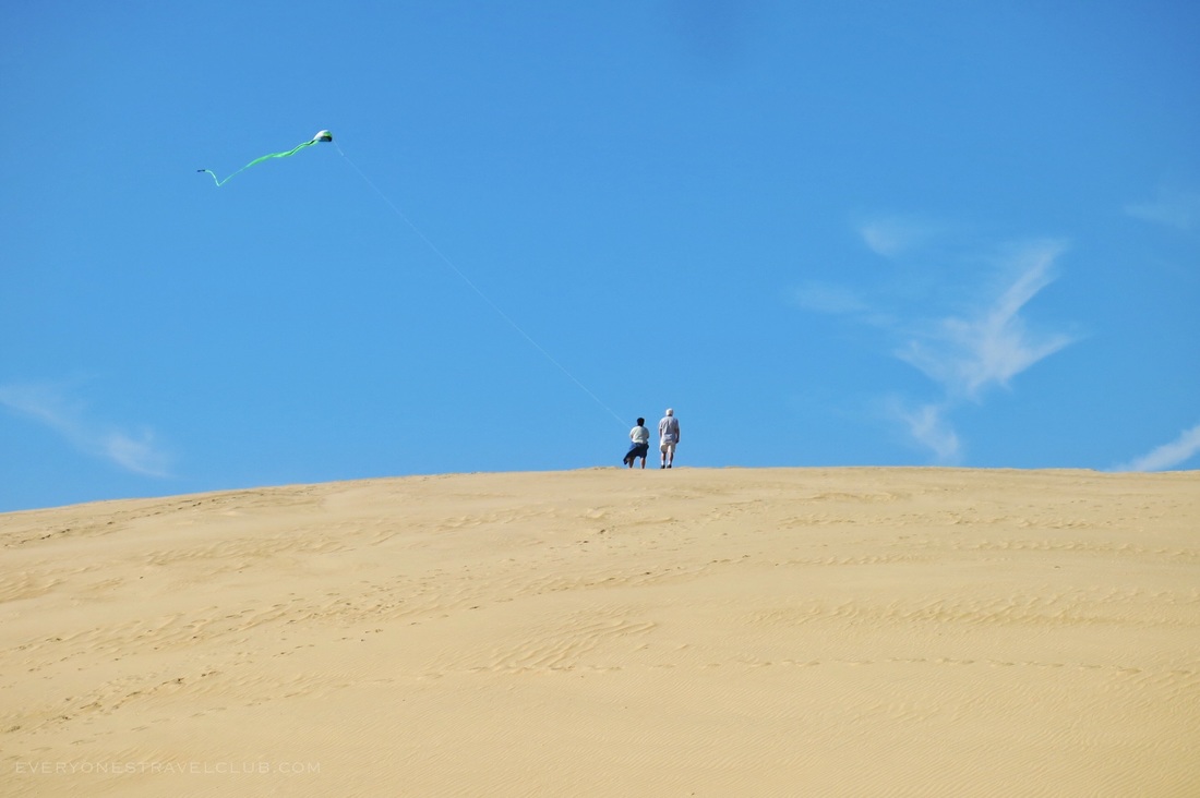 Flying a kite on the large sand dune at Jockey's Ridge State Park