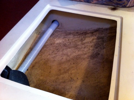 A moldy storage space in need of cleaning aboard our new sailboat.