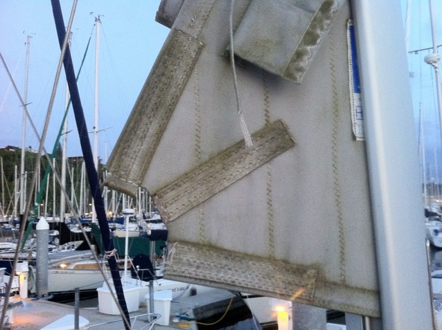 A torn clew on the mainsail of a 2000 Hunter 320 sailboat.