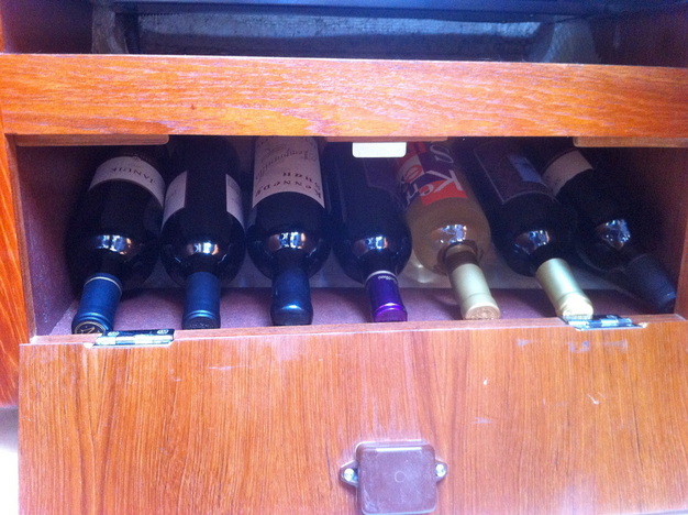 An under stove wine cellar aboard our sailboat.