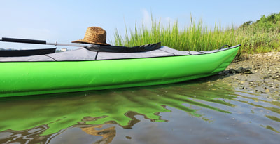 A beached Innova Inflatable Swing 2 kayak